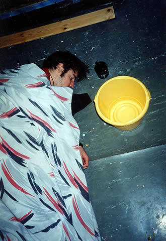 Ed, passed out on the bathroom floor, with bucket